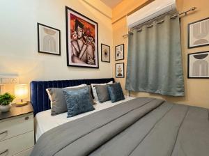 a bedroom with a large bed and a window at hotel elevate suites in Nagpur +9 photos