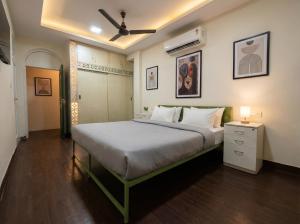 a bedroom with a large bed with a ceiling fan at hotel elevate suites in Nagpur