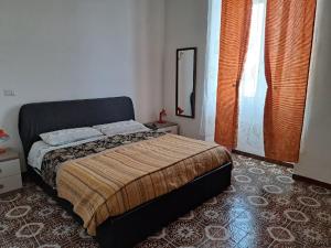 a bedroom with a bed and a mirror on the wall at Alloggio Turistico RELAX in Civitavecchia