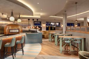 a restaurant with a bar with tables and chairs at Landal Dylan Coastal Resort in Laugharne