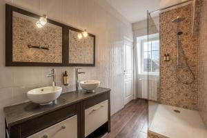 a bathroom with two sinks and a shower at Le Pavillon des Lys - Hôtel Particulier in Amboise +71 photos