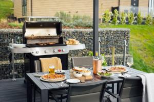 a table with plates of food and a grill at Landal Dylan Coastal Resort in Laugharne
