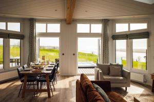 a living room with a table and a couch at Landal Dylan Coastal Resort in Laugharne +7 photos
