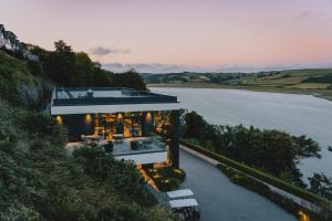an aerial view of a house next to a body of water at Landal Dylan Coastal Resort in Laugharne