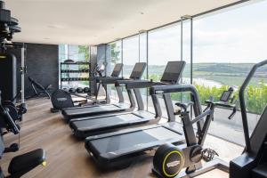 a row of treadmills in a gym with a view at Landal Dylan Coastal Resort in Laugharne