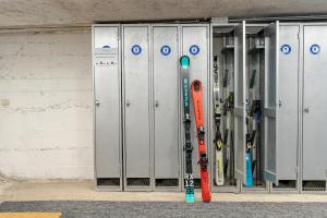 Un par de esquís y una tabla de snowboard en una máquina en Hotel Italo, en Madonna di Campiglio