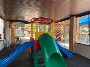 a playground with a slide in a building at Eldorado Thermas Park Localização Top área de Lazer Completa in Caldas Novas
