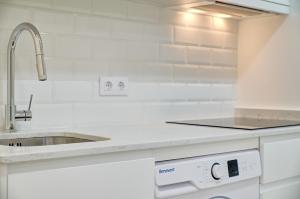 a white kitchen with a sink and a counter at Oasis by Clabao in Logroño +31 photos