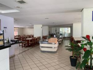 a restaurant with tables and chairs and a waiting room at Eldorado Thermas Park Localização Top área de Lazer Completa in Caldas Novas