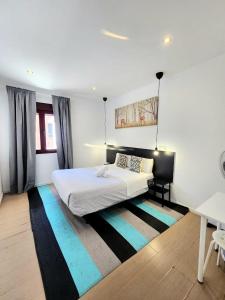 a bedroom with a large bed and a rug at AYZ Javier Cabrini - Auto check-in property in Madrid +120 photos