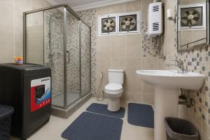 a bathroom with a toilet and a sink and a shower at 903 . Spacious 3BR Apt. 2 Baths Gated Community in Sheikh Zayed +38 photos