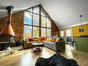 BaxterChalet w Hot Tub Fireplace Grill FirePit & Wifi的带沙发和石墙的客厅