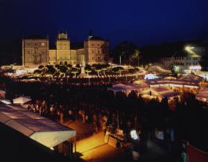 una multitud de personas de pie alrededor de un mercado por la noche en Kurhotel Bad Rodach an der ThermeNatur, en Bad Rodach