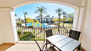 a balcony with a table and a view of a pool at Donna Olympia's House in Sucina