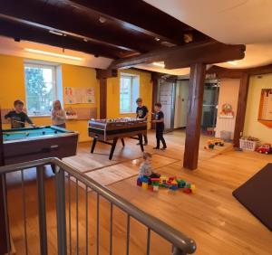 a group of children playing in a room with a pool table at Landhotel Schustermühle in Seefeld-Kadolz