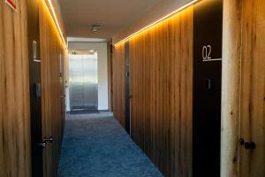 a hallway with wood paneling and a hallway with a door at Kronoguest - Auto check-in in Castañares