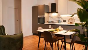 a kitchen with a table and chairs in a room at Palmarea House in Nebbiuno