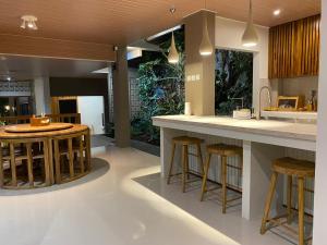 a kitchen with a island and bar stools at NOBE Villas in Salakan