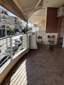 a kitchen with a balcony with a view of a city at Sparta Central Apartment with Free Parking in Sparta