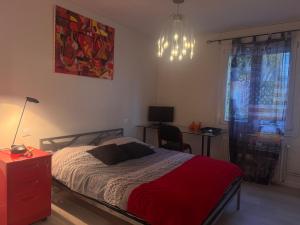 a bedroom with a bed and a desk and a lamp at La Maison du Routard in Évreux