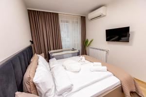 ein Krankenhauszimmer mit einem Bett mit weißen Kissen in der Unterkunft City Home Sandanski in Sandanski