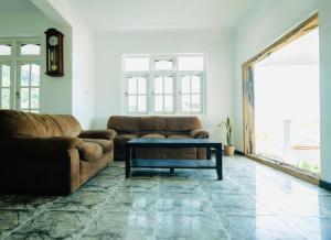 a living room with a couch and a coffee table at Cloud Nest Hanthana in Kandy