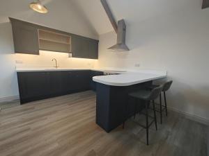 a kitchen with black cabinets and a white counter top at 1 Bed in Castleton oc-t34011 in Castleton +4 photos