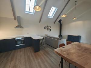 a kitchen and dining room with a wooden table at 1 Bed in Castleton oc-t34011 in Castleton