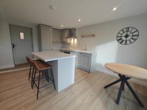 a kitchen with a counter and a table and stool at 2 Bed in Castleton oc-f34013 in Castleton