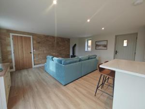 a living room with a blue couch and a table at 2 Bed in Castleton oc-f34013 in Castleton