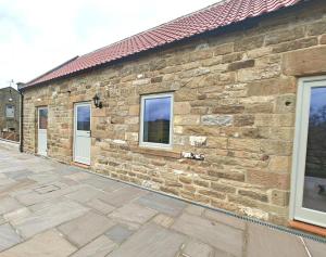 a stone building with two windows and a patio at 2 Bed in Castleton oc-f34013 in Castleton