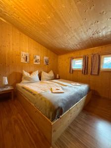 a bedroom with a bed in a wooden cabin at Ferienhaus Messner in Hohentauern