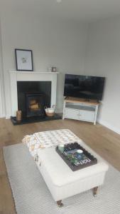 a living room with a couch and a fireplace at Clochan na Mara - Liscannor, County Clare & Wild Atlantic Way in Liscannor