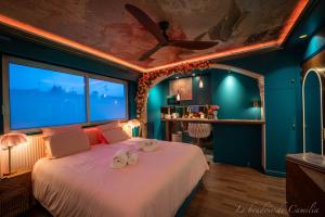 a bedroom with a large bed with towels on it at Le Boudoir in Vallauris