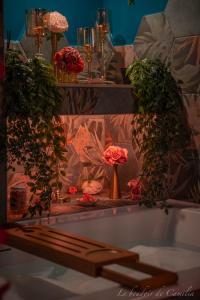 a bath tub with flowers on top of it at Le Boudoir in Vallauris