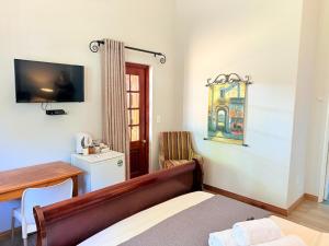 Una televisión o centro de entretenimiento en Kniff un Gaffel Guest House