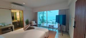 a bedroom with a white bed and a large window at Pebble Lanta - Seaview Stay in Ko Lanta +24 photos