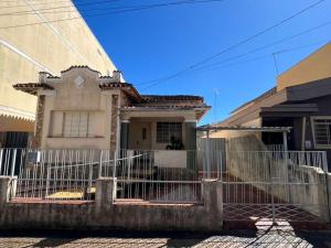 a white fence in front of a house at Casa Matias in Socorro