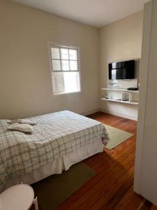 a bedroom with a bed and a window and a television at Casa Matias in Socorro