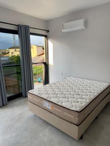 Postel nebo postele na pokoji v ubytování Riviera de Garopaba Unidade Vista Mar