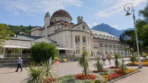 Un gran edificio con gente caminando frente a él. en Appartment Maria, en Scena