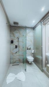 a bathroom with a glass shower and a toilet at TheMirell Hôtel Dakhla in Dakhla +67 photos