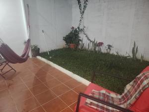a room with a patio with a yard with plants at Casa Socorrito in Ahuachapán