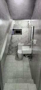 a bathroom with a white toilet and a sink at Peaceful Villa by Oceanaxe Holidays in Grand Baie