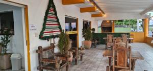 a restaurant with a christmas tree on the wall at HOTEL DOM BOSCO Itanhaém in Itanhaém
