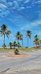 a street with palm trees on the side of a road at HOTEL DOM BOSCO Itanhaém in Itanhaém