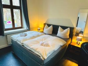 a bedroom with a bed with two wedding pillows on it at Hotel an der Rennbahn Kostenloses Parken in Dresden