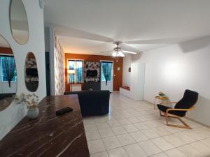 a living room with a couch and a table at iledo in La Cotinière