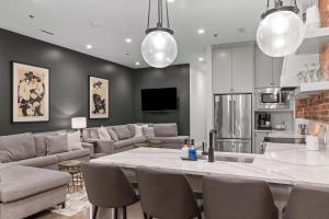 a kitchen and living room with a table and chairs at French's Luxury Condo - Steps from Broadway in Nashville