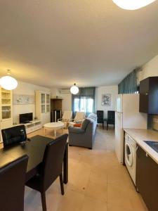 a kitchen and living room with a couch and a table at La Casa De Marta in Piedralaves